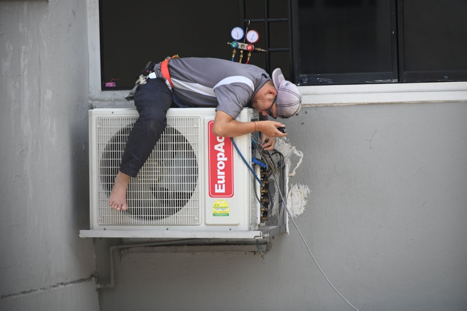 Smiling HVAC technician in uniform